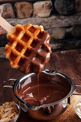 Belgium waffles with chocolate sauce. popsicles with chocolate and wafer.