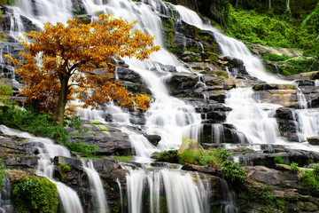 Beautiful waterfall in tropical forest in autumn at Chiang Mai, Thailand.