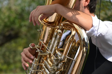 hands playing a saxophone