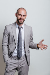 Portrait of a successful businessman in a suit, business coach / consulting. Studio shot with a flipchart on a white background.