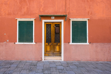 Fototapeta na wymiar old houses with scraped walls or shoking colours, rusty doors or windows