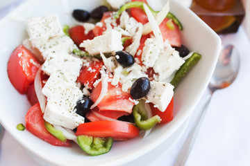 Greek salad with fresh vegetables, feta cheese and black olives