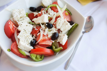 Greek salad with fresh vegetables, feta cheese and black olives