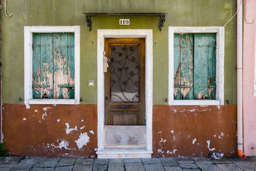 old houses with scraped walls or shocking colours, rusty doors or windows