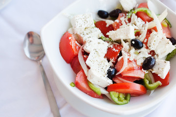 Greek salad with fresh vegetables, feta cheese and black olives