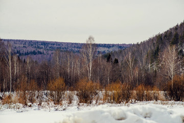 Sun among the mountain peaks. Beautiful winter landscape,the harsh, cold winter Altai, Severe...