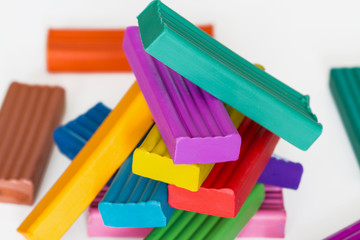 Pile of colorful plasticine sticks on light background. Selective focus