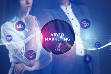 The concept of business, technology, the Internet and the network. A team of business women working on the virtual screen of the future and see the inscription: Video marketing