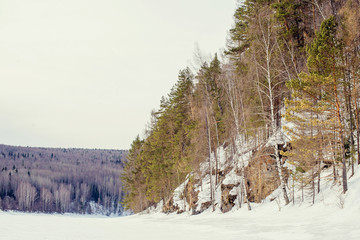 Sun among the mountain peaks. Beautiful winter landscape,the harsh, cold winter Altai, Severe...