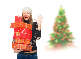 Woman in a winter sweater holding boxes with gifts. Beautiful girl on white background. Winter concept of advertising information. Christmas mood. Smiling woman with many gift boxes. New year concept