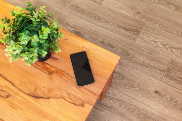 Mobile phone with blank screen mockup on wood table background