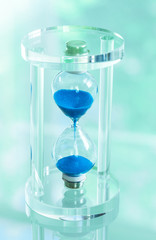 Time passing. Blue hourglass.