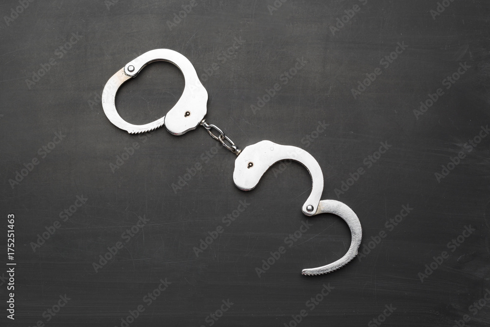 Wall mural police handcuffs isolated on black background