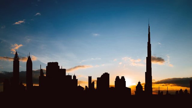Timelapse of Dubai cityscape silhouette on sunset in UAE