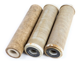 Dirty water filter cartridges on white background
