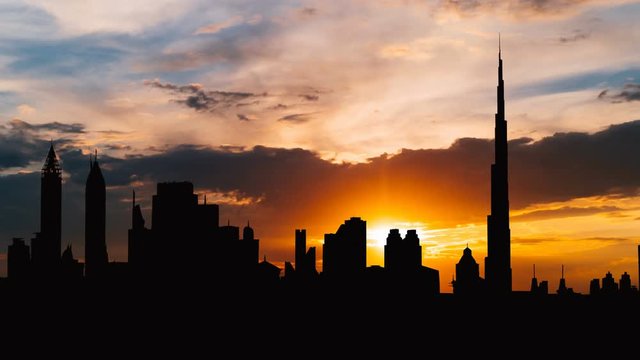 Timelapse of Dubai cityscape silhouette on sunset in UAE