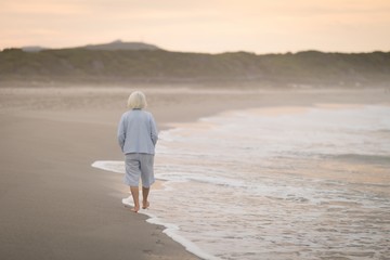 Senior woman walking on the beach