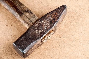 Old vintage hammer with wooden handle on wooden background, horizontal image