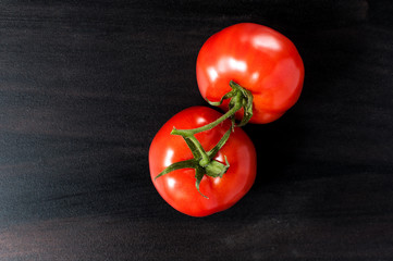 two flat lay fresh delicious red organic tomato on grey old kitchen table, horizontal image