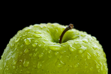Closeup of the green apple with drops of watter