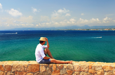 Man enjoys sea view at summer resort