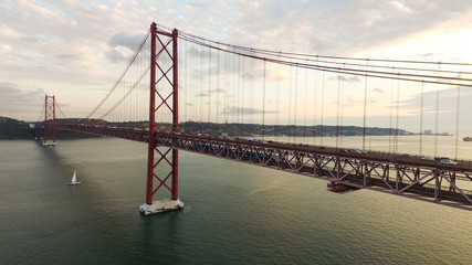 Bridge Ponte 25 de Abril over the Tagus river in Lisbon, Portugal at evening aerial view