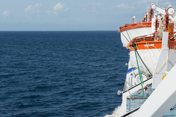 red and white lifeboats on board the ferry