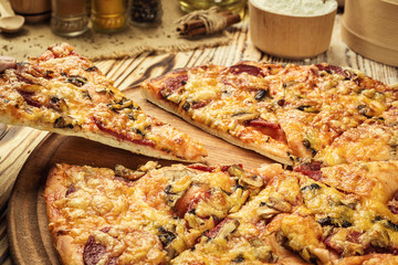 Hot pizza slice with melting cheese on a rustic wooden table.pepperoni pizza,Hot Homemade Pepperoni Pizza Ready to Eat,Supreme Pizza lifted slice, cheese stringy slice lifted of full supreme pizza