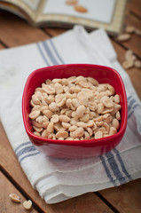 Salted mani served in red bowl