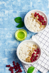 Healthy oatmeal breakfast with honey, red currant. Top view, space for text. 
