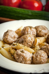 Pork meatballs with dill sauce and pasta. Selective focus.