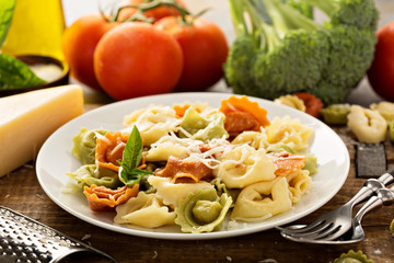 Red, white and green tortellini with vegetables and cheese