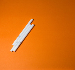 A top view image of several commercially made cigarettes.