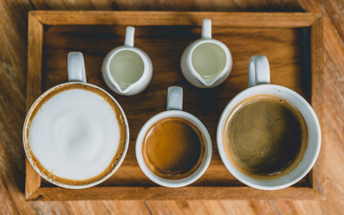 Obraz na płótnie Canvas Hot Espresso, Hot Cappuccino And Hot Americano On Wooden Tray 