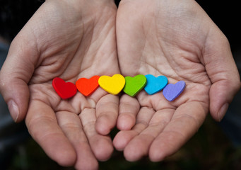 Background of LGBT .hearts of the color of the rainbow in  hand