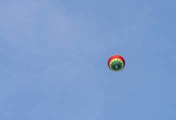 A balloon is flying in the blue sky. Colorful hot air balloon against blue sky