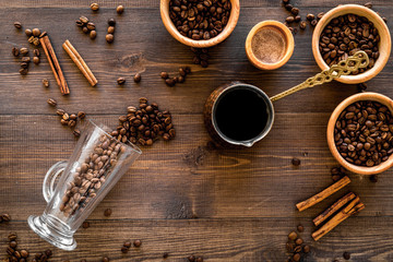 Make coffee in turkish coffee pot. Wooden background top view copyspace