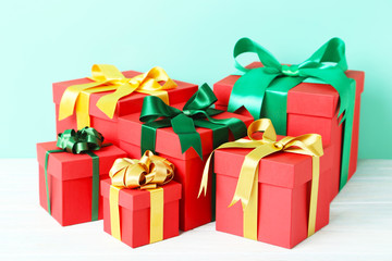 Gift boxes with ribbon on white wooden table