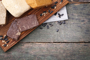 Tasty pieces of halva on brown cutting board