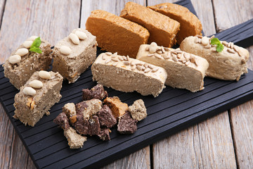 Tasty slices of halva on cutting board