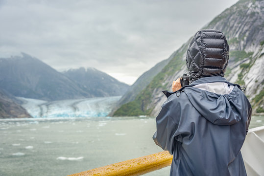 cruise ship with visitor taking photo of a glacier in glacier bay national park in Alaska