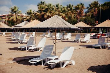 Beach loungers and umbrella on sunset, nobody