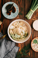 dumplings with potatoes, cheese, berries, compositions for the menu of the restaurant, decorated with greens and sauce