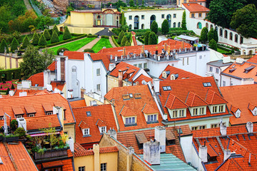 Obraz premium Top view to red tile roofs of Prague city Czech republic. Typical Prague houses