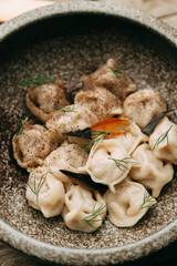 dumplings with potatoes, cheese, berries, compositions for the menu of the restaurant, decorated with greens and sauce