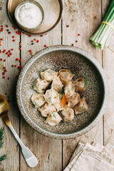 dumplings with potatoes, cheese, berries, compositions for the menu of the restaurant, decorated with greens and sauce