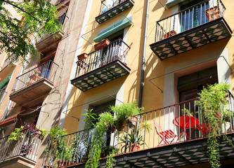 Fototapeta na wymiar Spanish balconies decorated with pots with green plants