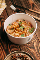 dumplings with potatoes, cheese, berries, compositions for the menu of the restaurant, decorated with greens and sauce