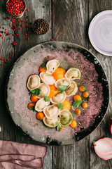 dumplings with potatoes, cheese, berries, compositions for the menu of the restaurant, decorated with greens and sauce