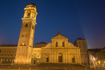 Fototapeta na wymiar Turin - The portal and tower of Duomo at dusk.